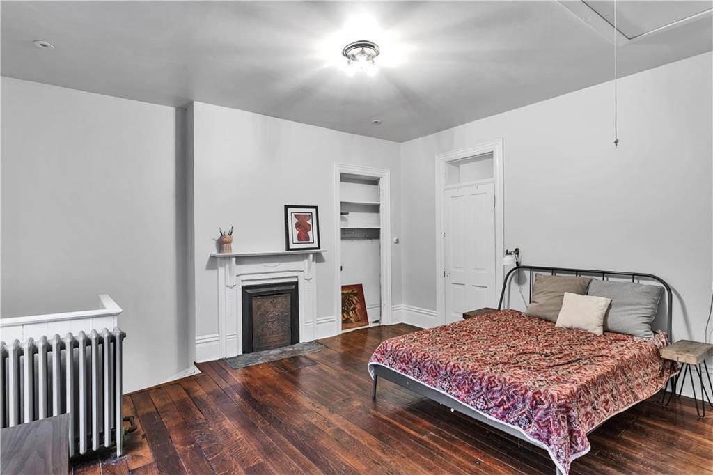 389 East Rices Landing Road East Millsboro, PA 15433 - Photo 30 of 42 Original wooden floors provide classic charm in this bedroom with its decorative fireplace.
