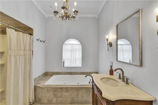 a bathroom with a tub sink and mirror