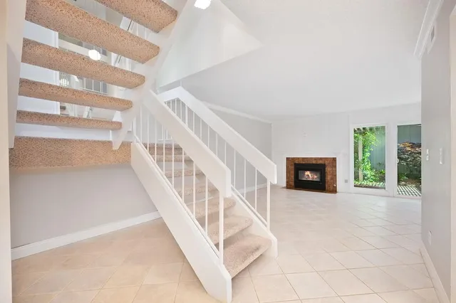 a view of an empty room with a fireplace