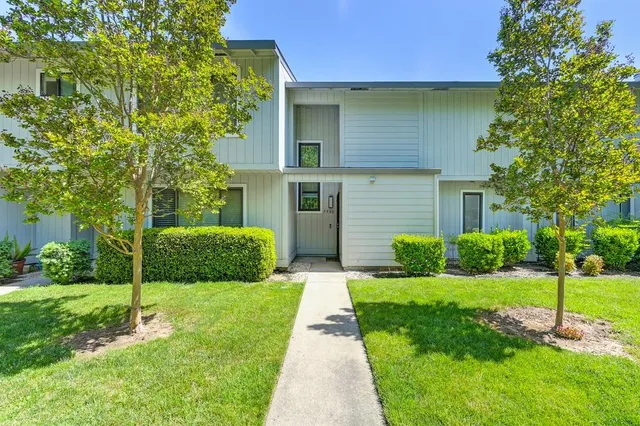 a front view of a house with garden