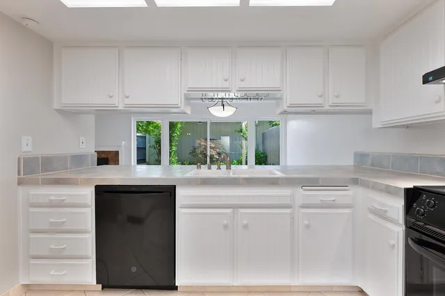 a kitchen with stainless steel appliances a refrigerator and a stove top oven
