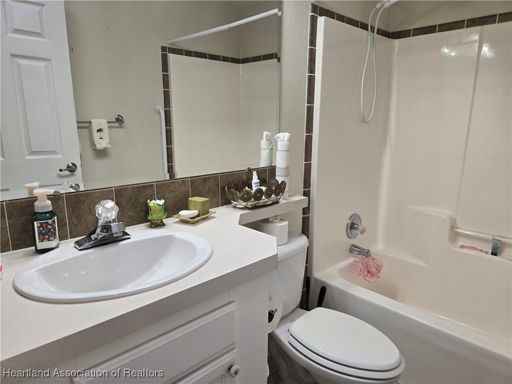 3312 Beartooth Pass Sebring, FL 33872 - Photo 17 of 39 a bathroom with a sink toilet and shower