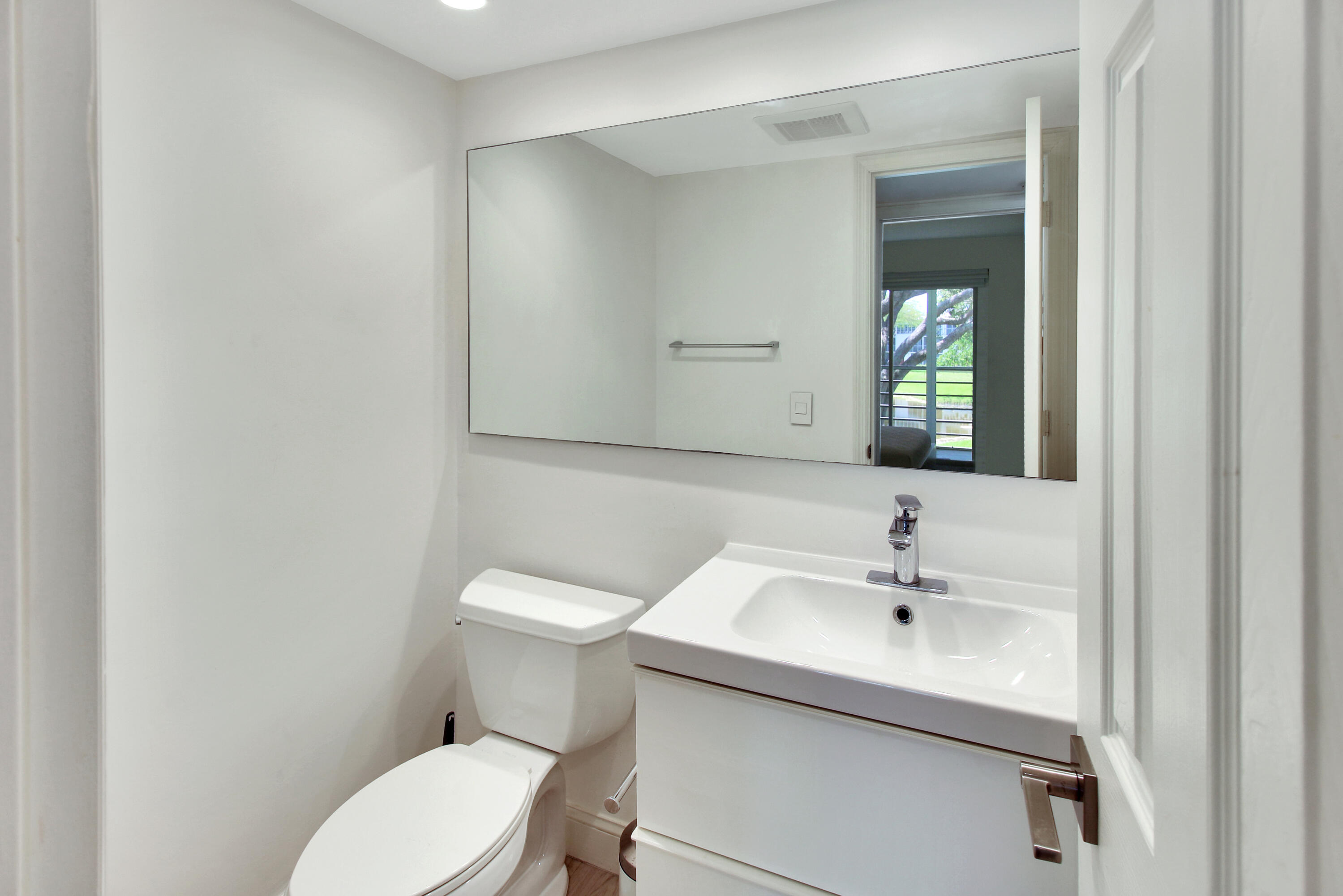 17 Fanshaw A Boca Raton, FL 33434 - Photo 10 of 11 a bathroom with a toilet sink and mirror