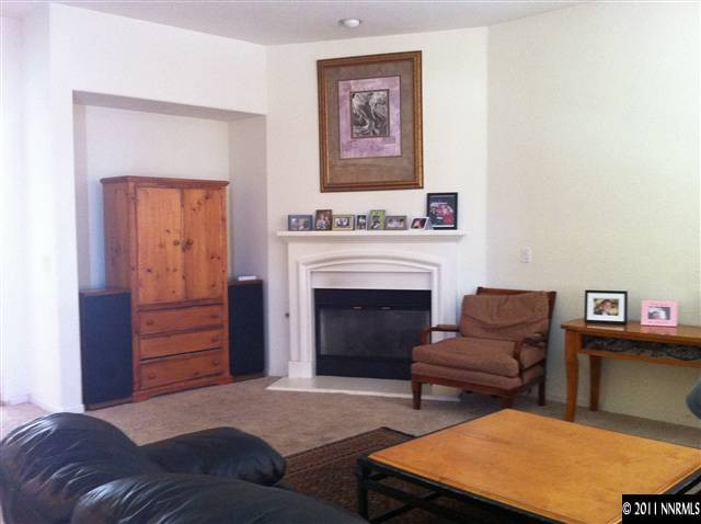 10735 Ivy Gate Court Reno, NV 89521 - Photo 5 of 12 a bedroom with furniture and a fireplace