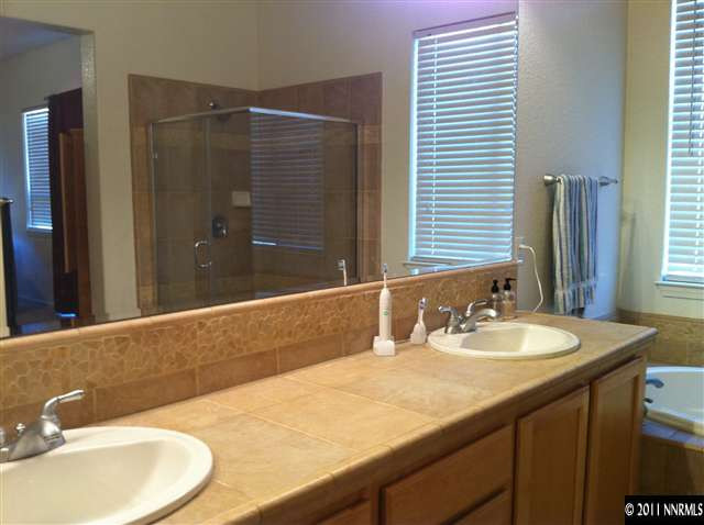 10735 Ivy Gate Court Reno, NV 89521 - Photo 10 of 12 a bathroom with a granite countertop sink and a mirror