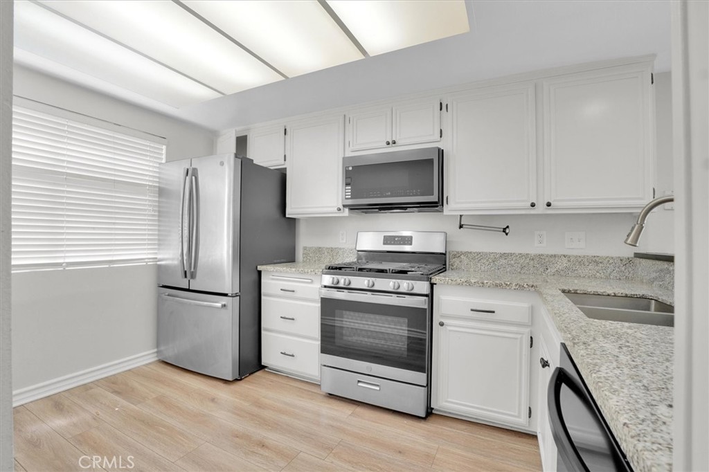 5610 Las Virgenes Road, Unit 50 Calabasas, CA 91302 - Photo 11 of 40 a kitchen with a stove microwave and refrigerator