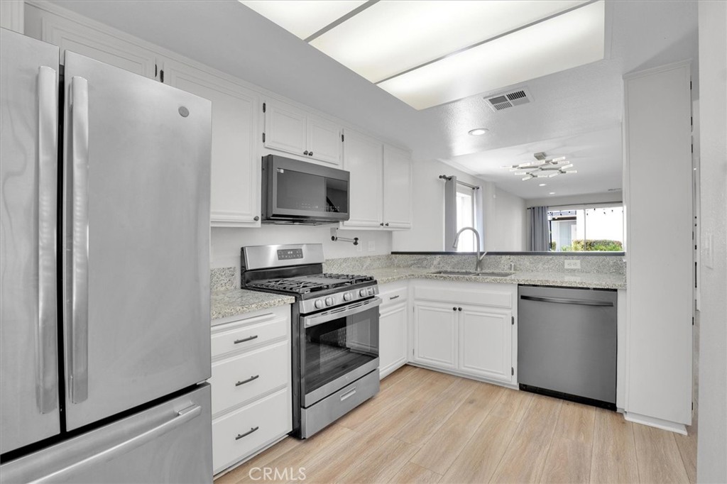 5610 Las Virgenes Road, Unit 50 Calabasas, CA 91302 - Photo 14 of 40 a kitchen with a sink stove and refrigerator