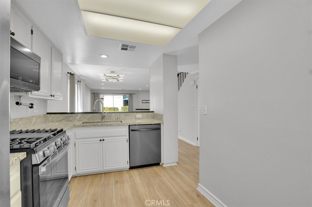 5610 Las Virgenes Road, Unit 50 Calabasas, CA 91302 - Photo 15 of 40 a kitchen with stainless steel appliances granite countertop a stove a sink and a refrigerator