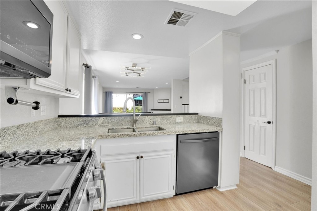 5610 Las Virgenes Road, Unit 50 Calabasas, CA 91302 - Photo 16 of 40 a kitchen with a sink stove and cabinets