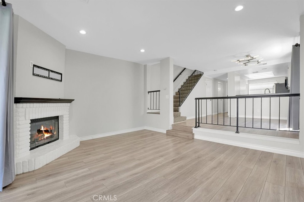 5610 Las Virgenes Road, Unit 50 Calabasas, CA 91302 - Photo 2 of 40 a view of an empty room with wooden floor fireplace and a window