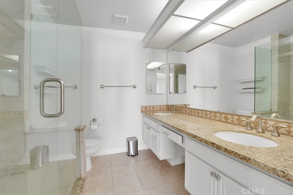 5610 Las Virgenes Road, Unit 50 Calabasas, CA 91302 - Photo 26 of 40 a bathroom with a granite countertop sink and a mirror