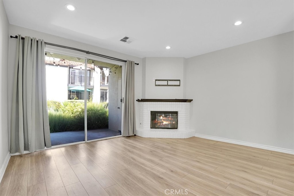 5610 Las Virgenes Road, Unit 50 Calabasas, CA 91302 - Photo 6 of 40 an empty room with wooden floor and a fireplace