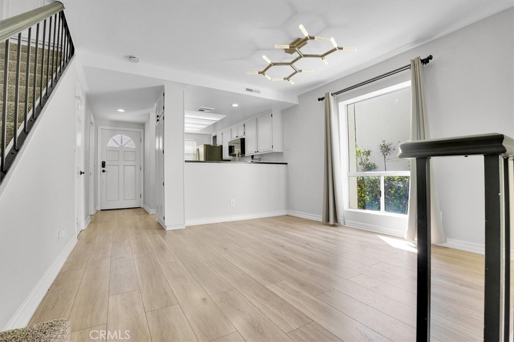 5610 Las Virgenes Road, Unit 50 Calabasas, CA 91302 - Photo 7 of 40 a view of a kitchen with wooden floor and a ceiling fan