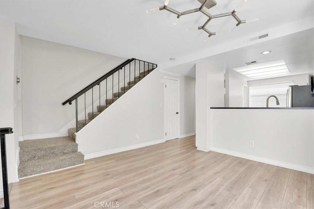 5610 Las Virgenes Road, Unit 50 Calabasas, CA 91302 - Photo 8 of 40 a view of a hallway with wooden floor and staircase