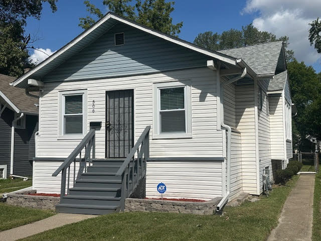 506 East 144th Place Dolton, IL 60419 - Photo 3 of 37 a front view of a house with a yard