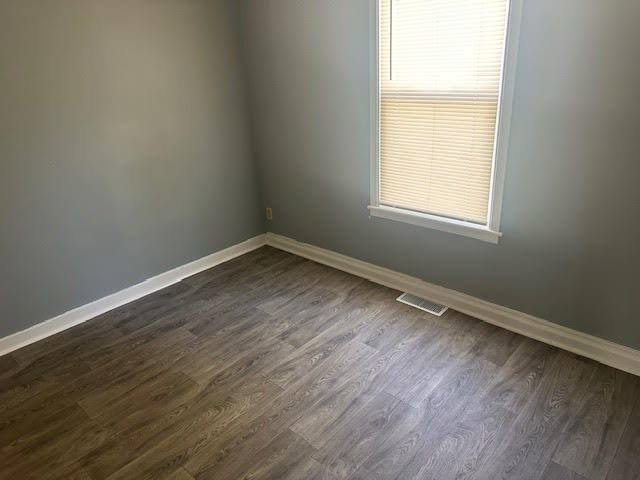 506 East 144th Place Dolton, IL 60419 - Photo 31 of 37 an empty room with wooden floor and windows
