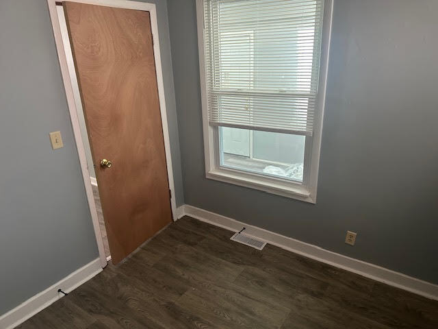 506 East 144th Place Dolton, IL 60419 - Photo 32 of 37 an empty room with wooden floor and windows