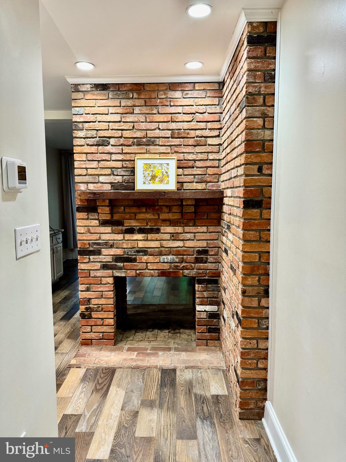 739 McHenry Street Baltimore, MD 21230 - Photo 5 of 30 Living room to kitchen - fireplace
