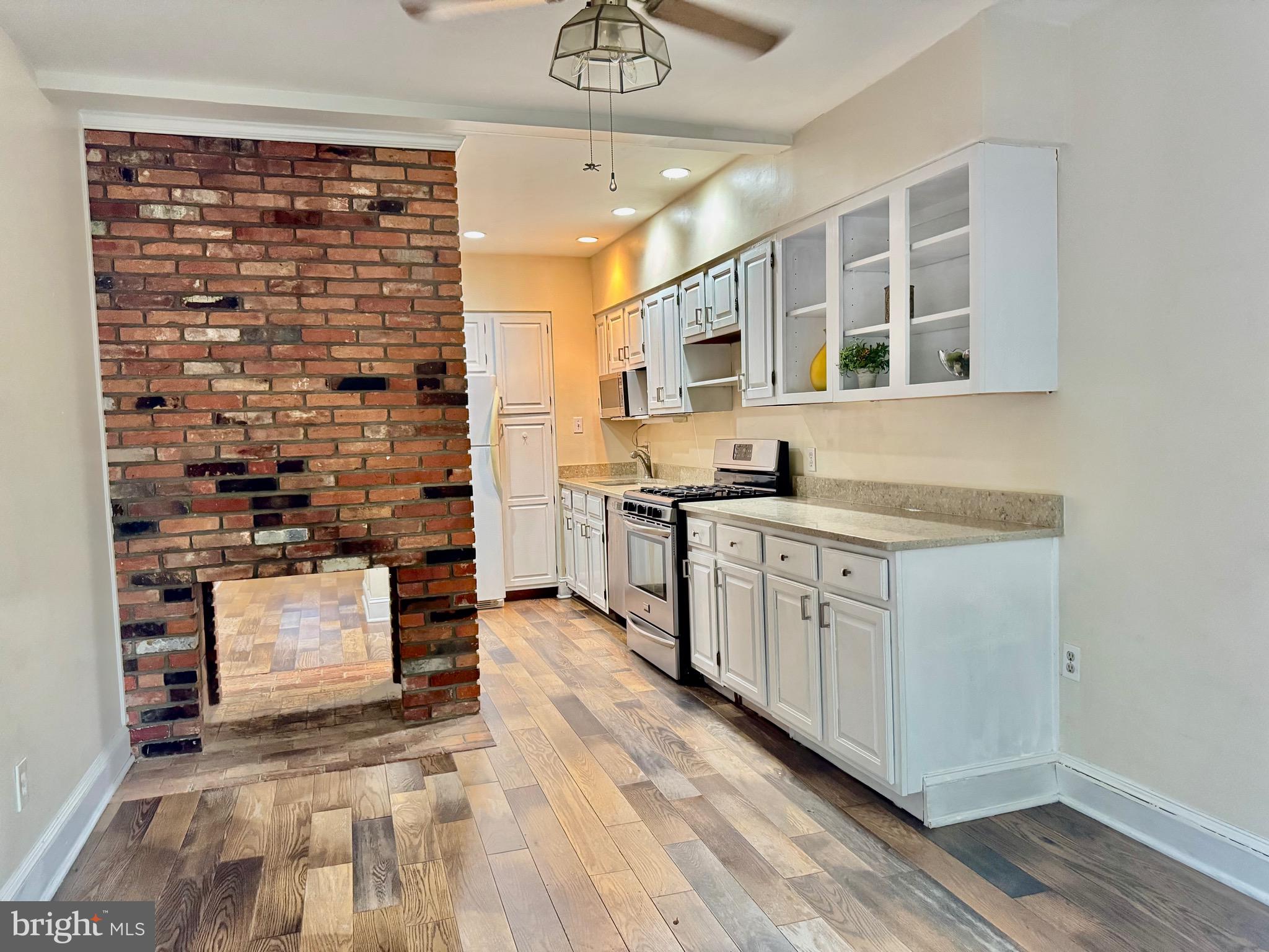 739 McHenry Street Baltimore, MD 21230 - Photo 6 of 30 Double sided fireplace between kitchen and family