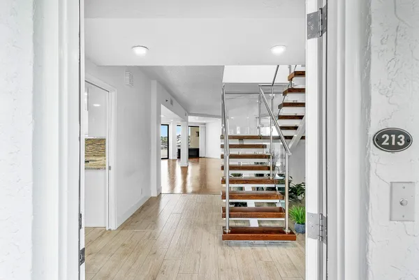 a view of entryway and hall with wooden floor