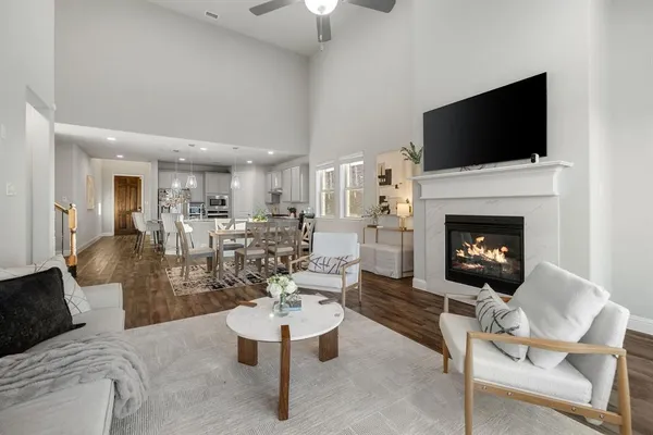 a living room with furniture a flat screen tv and a fireplace