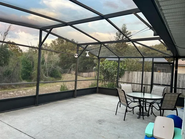a view of a room with furniture and a window