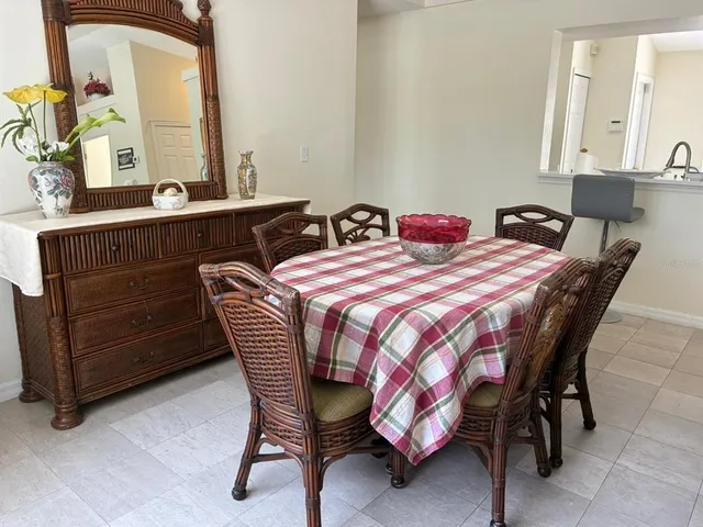 a bedroom with a bed a dresser and mirror