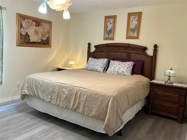 a bedroom with a bed and a painting on the wall