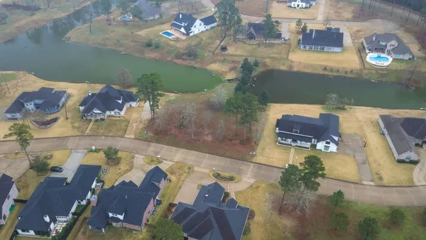 an aerial view of residential houses with outdoor space