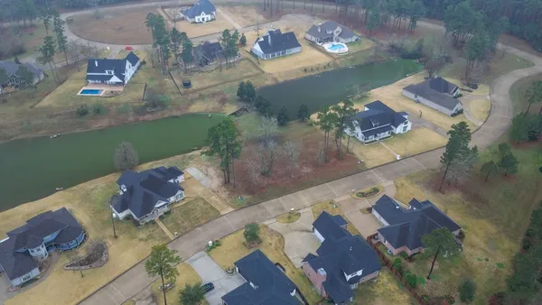 an aerial view of a house with a yard