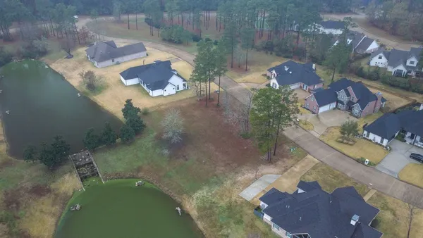 an aerial view of a house with yard