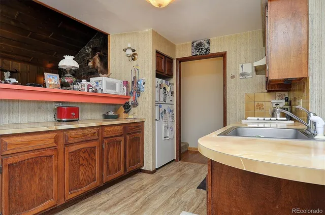 a kitchen with granite countertop a sink cabinets stainless steel appliances and a counter top space