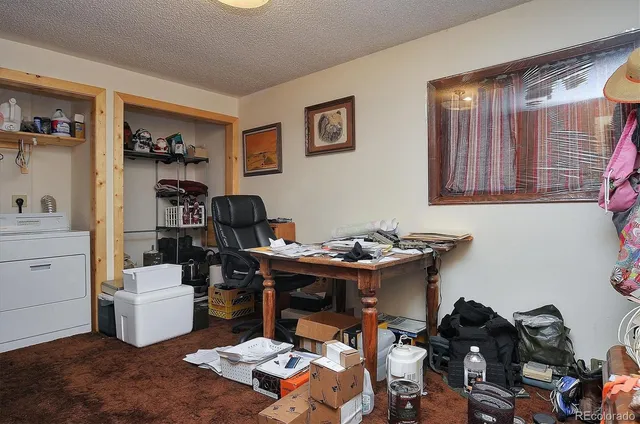 a view of a workspace with furniture and toys