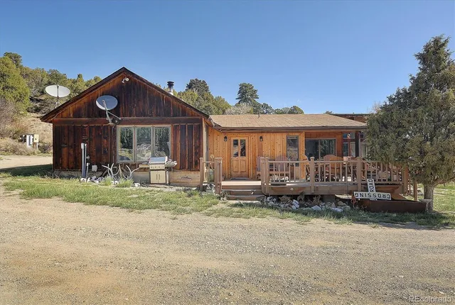 a front view of a house with a yard table and chairs