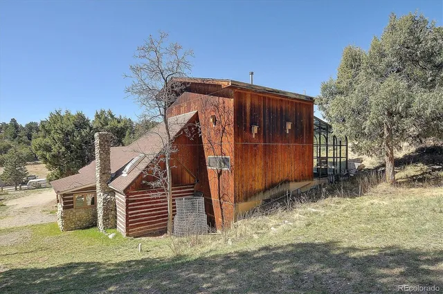 a view of a house with a wooden fence