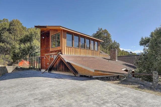 a view of backyard with deck and slide