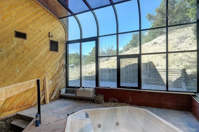 a bathroom with a bathtub and large window