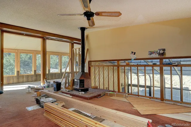 a living room with hardwood floor and large windows