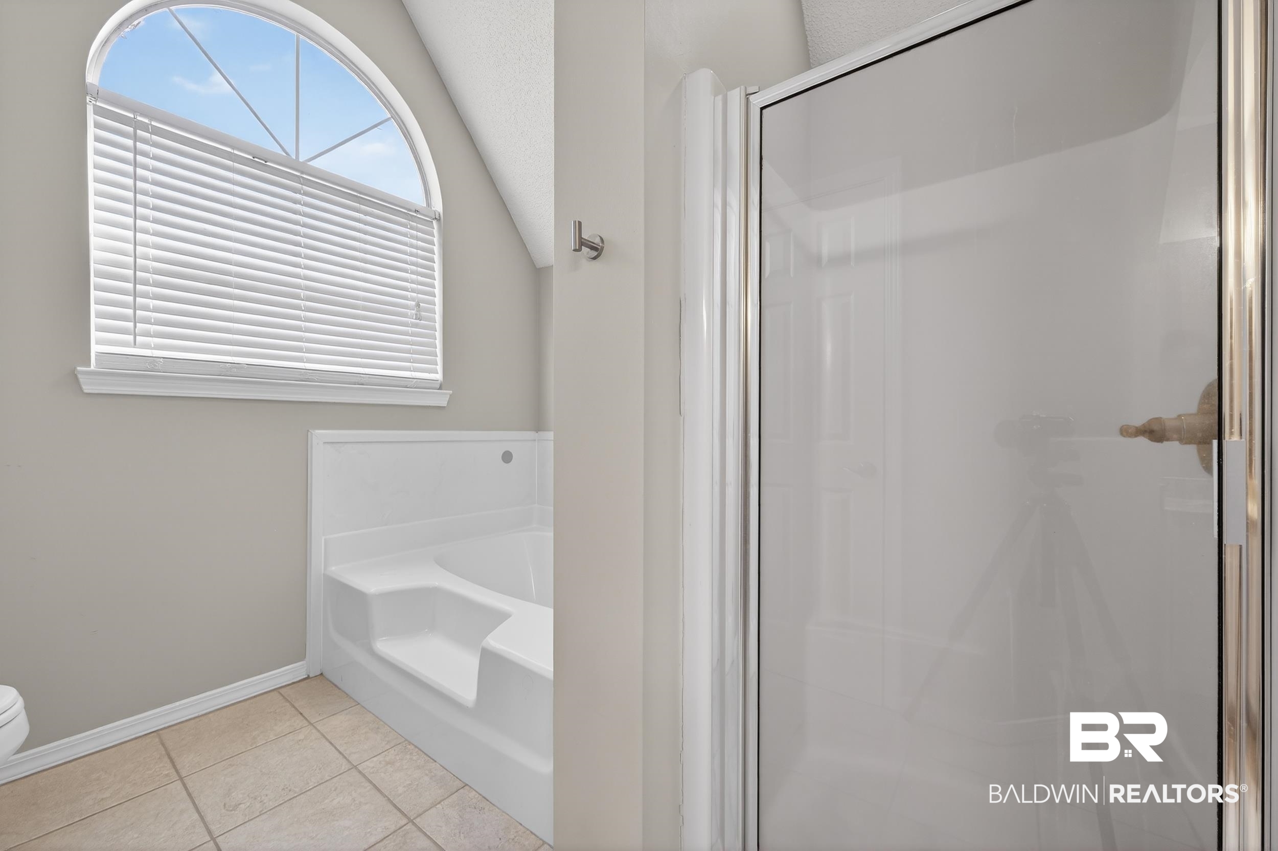 7050 Highpointe Place West Daphne, AL 36527 - Photo 50 of 66 Bathroom featuring a stall shower, a garden tub, light tile patterned floors, and lofted ceiling