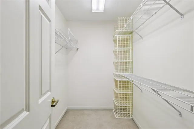 a view of walk in closet with clothes