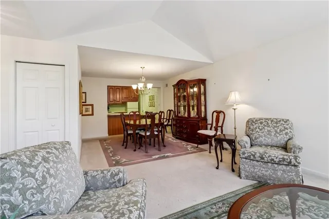 a living room with furniture and dining area
