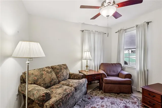 a living room with furniture a couch and a chandelier