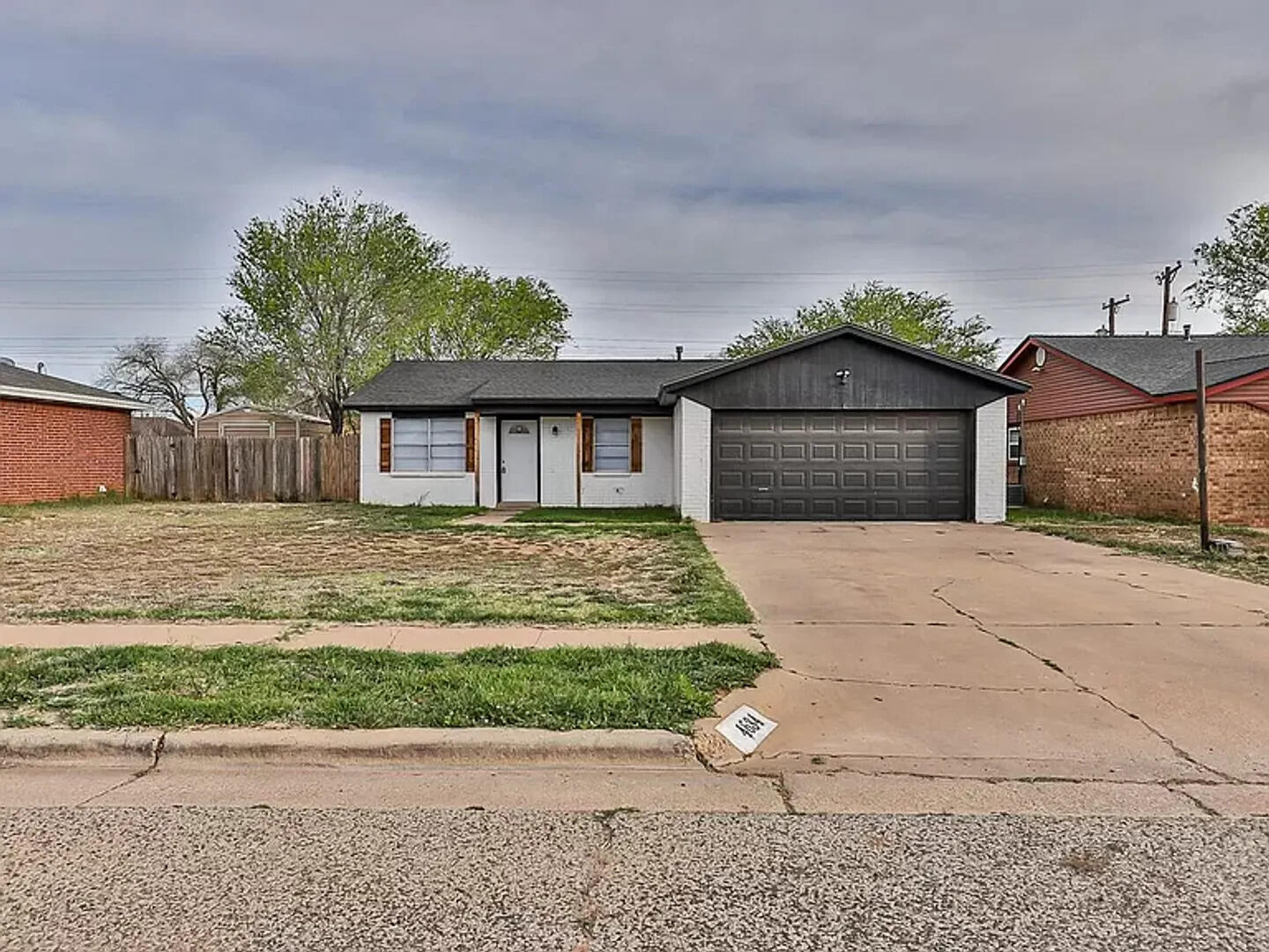 4634 Fordham Street Lubbock, TX 79416 - Photo 1 of 16 a front view of a house with a yard and garage