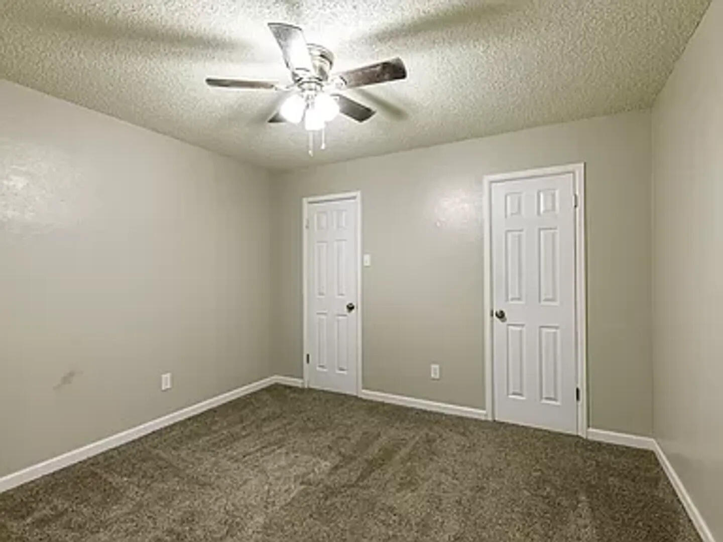 4634 Fordham Street Lubbock, TX 79416 - Photo 13 of 16 an empty room with windows and fan