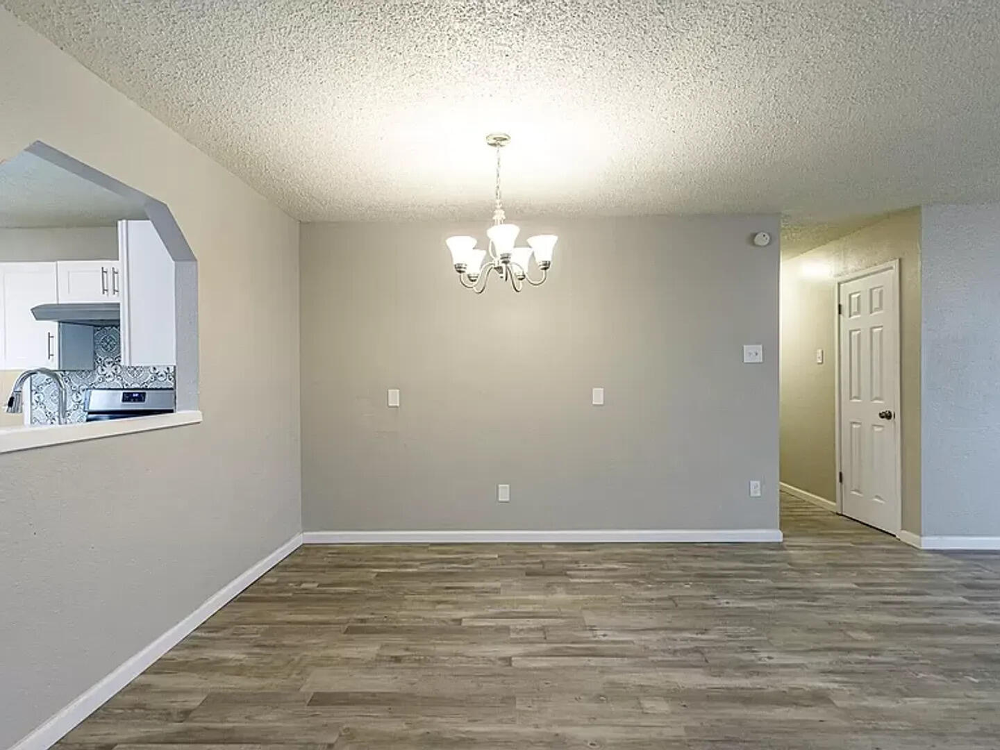 4634 Fordham Street Lubbock, TX 79416 - Photo 5 of 16 a view of an empty room with window and wooden floor