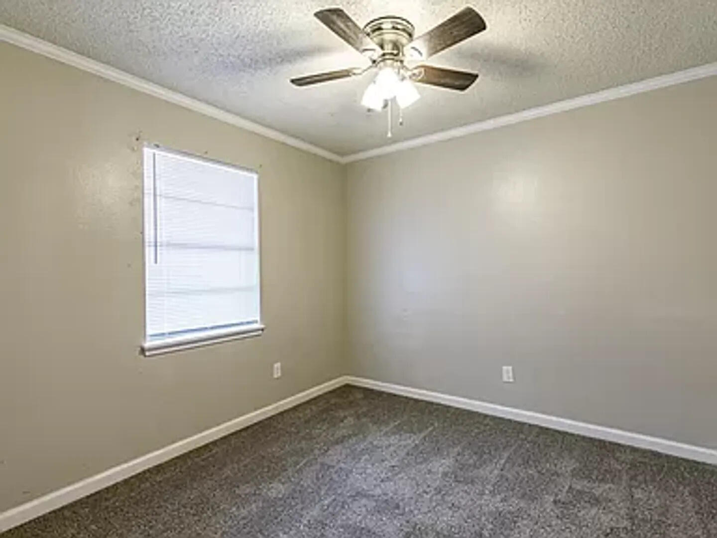 4634 Fordham Street Lubbock, TX 79416 - Photo 6 of 16 an empty room with a window and a fan