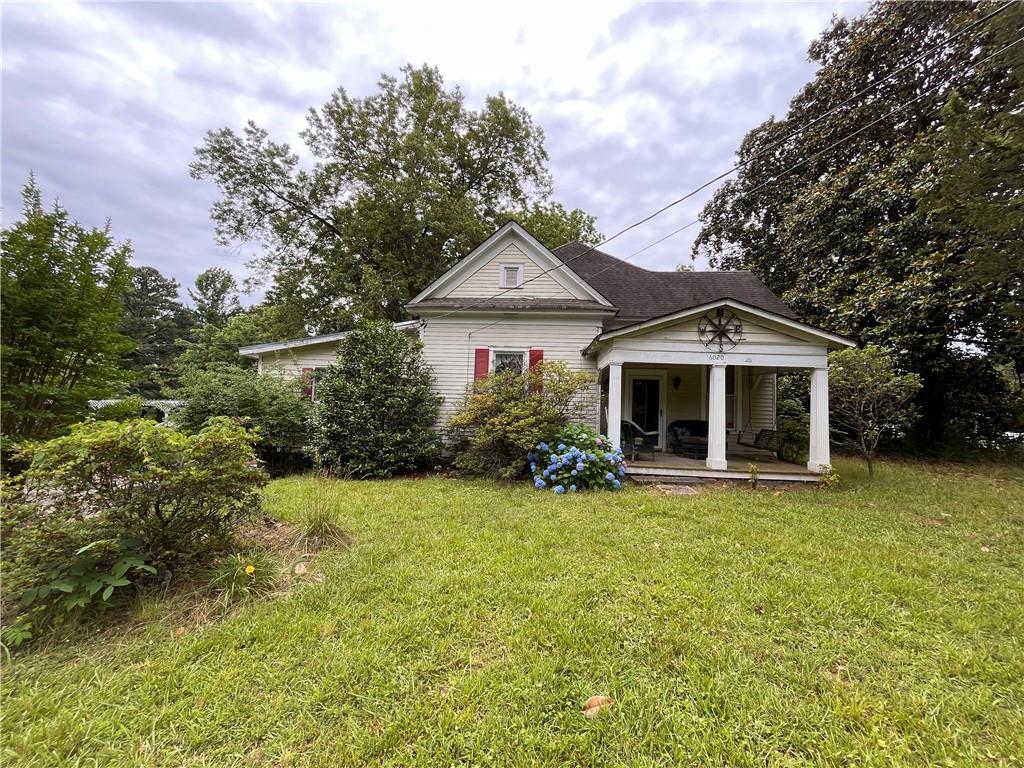 6020 Dodson Road Fairburn, GA 30213 - Photo 1 of 1 a front view of a house with a garden
