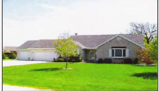 a view of a house with a yard and a garden