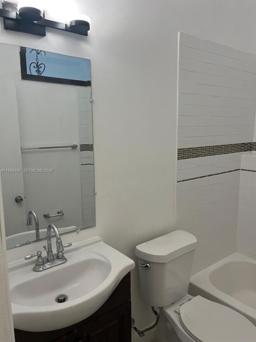 7133 Southwest 109th Court Miami, FL 33173 - Photo 8 of 13 a bathroom with a sink toilet and shower