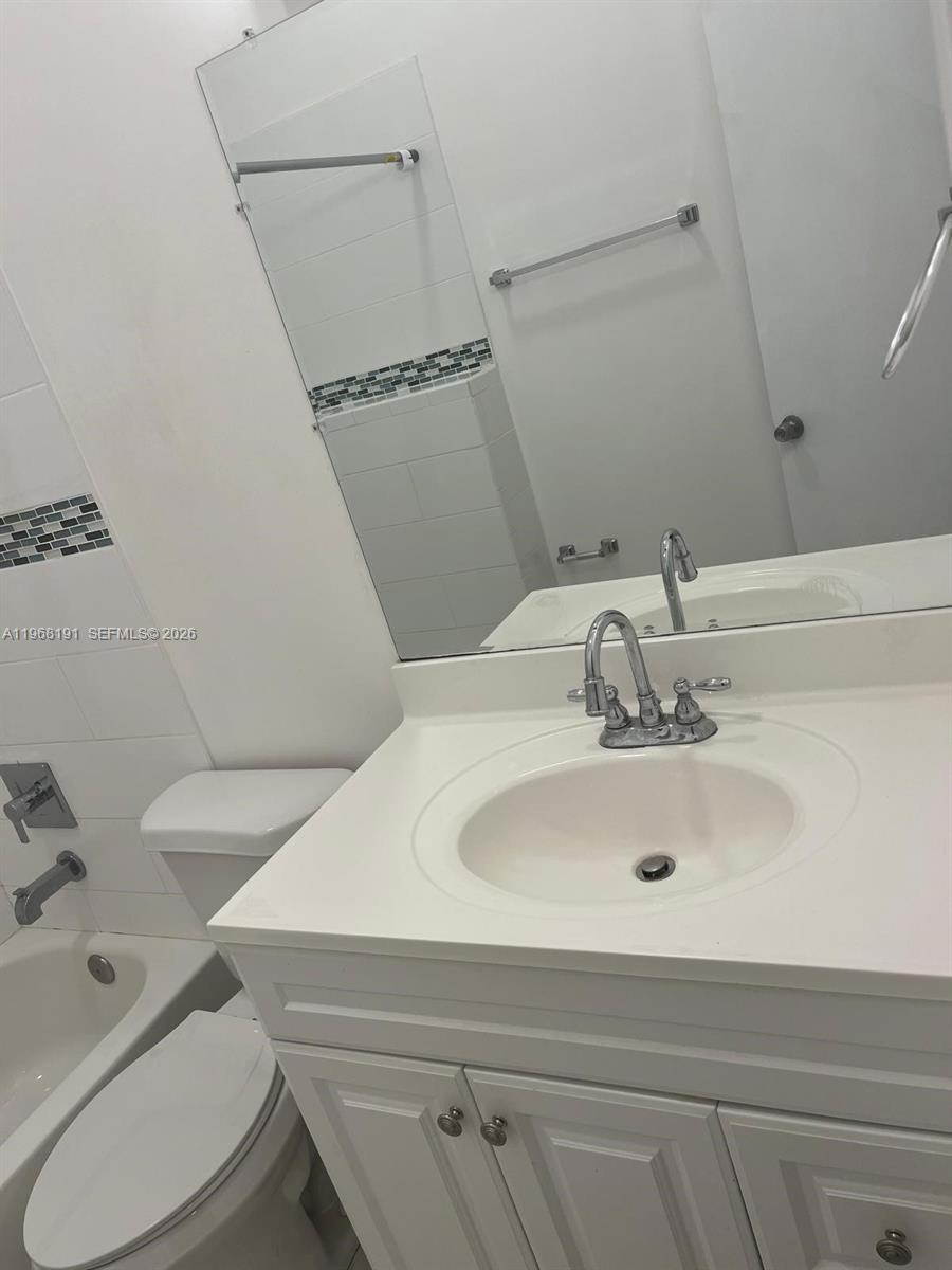 7133 Southwest 109th Court Miami, FL 33173 - Photo 10 of 13 a bathroom with a sink and a toilet